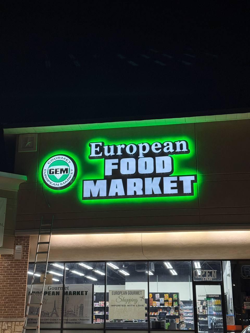 Gourmet European Market Dallas storefront at night